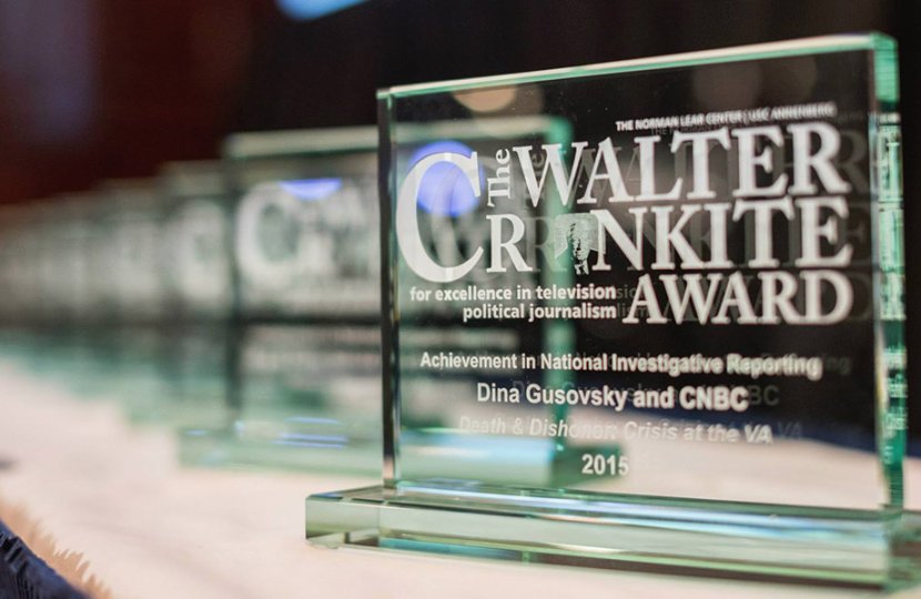 rectangular shaped glass awards lined up in a row with the words Walter Cronkite Award written on them
