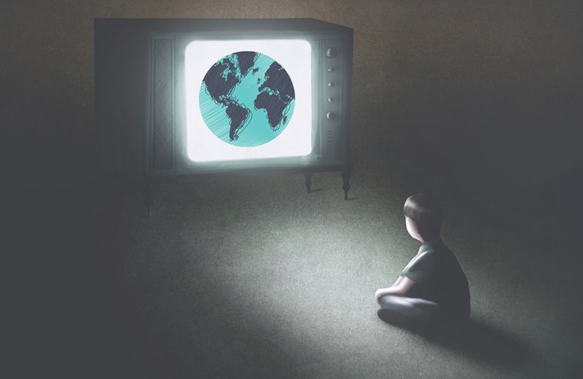 Image of person in a dark room watching a television that shows planet Earth