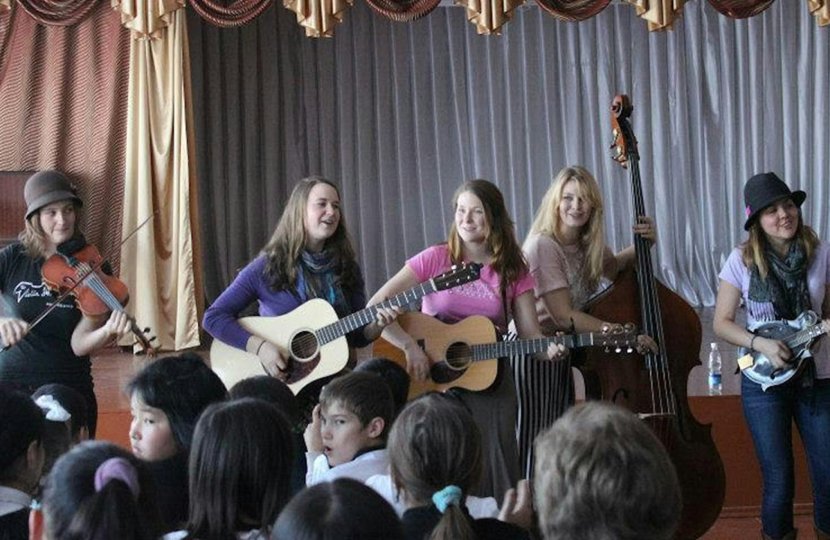 The bluegrass group Della Mae plays at an orphanage in Kyrgyzstan on its State Department-sponsored American Music Abroad tour in 2012. Photo: Paul Rockower