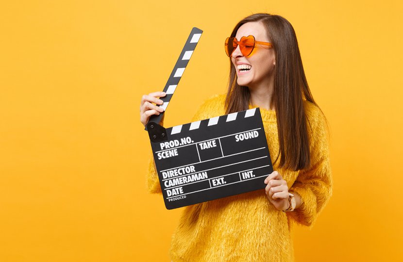 Photo of a person holding a movie clapperboard