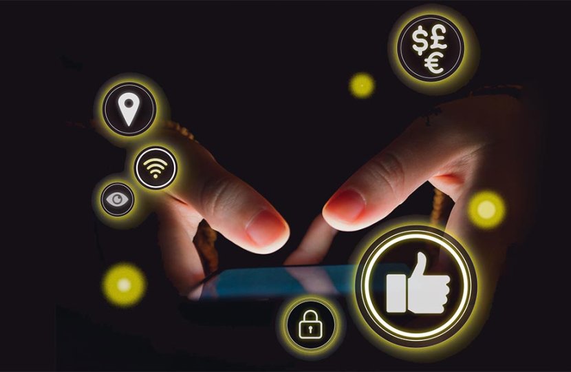 Out of the black darkness, a phone screen lights up with two thumbs touching the screen. Social media-related icons hover in yellow circles around it.