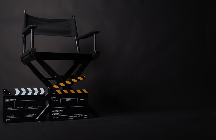 A director's chair over a blank black screen. 