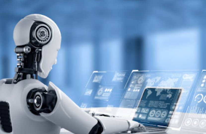 A robot typing on a laptop, sitting at a desk