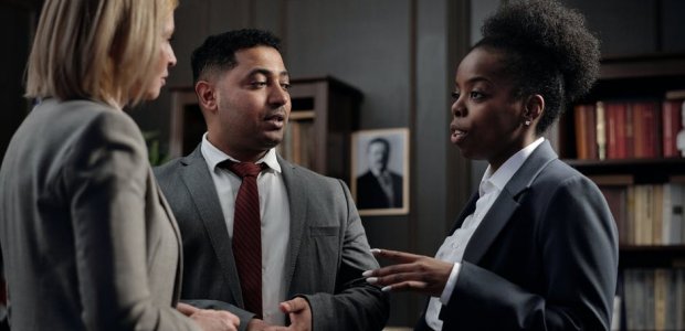 Photo of three people in formal wear conversating