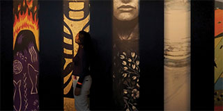 A woman standing in an art museum.